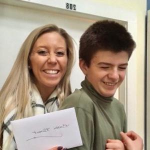 A student and teacher smiling in the Schoolhouse.